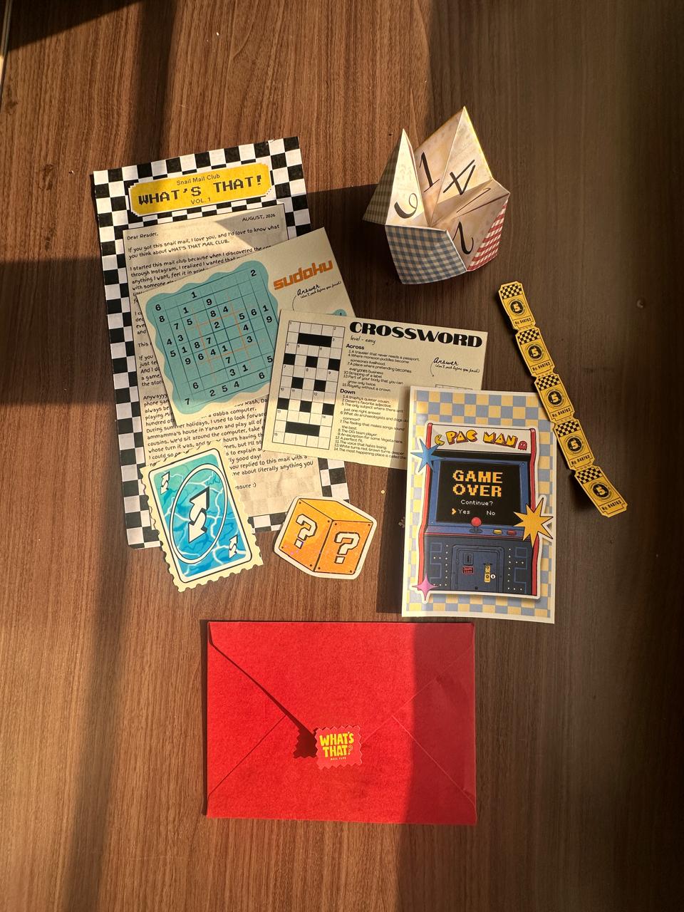 What's That? Mail Club envelope and August contents photographed in real life